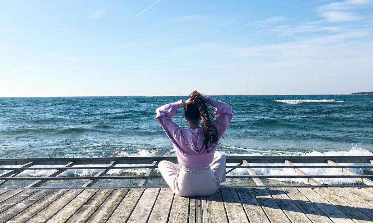 Woman sitting overlooking the ocean